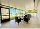 Relaxing screened patio with tile flooring, ceiling and modern patio furniture at 2141 Holiday Dr, Holiday, FL 34691