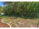 Fenced backyard features a fire pit, offering a cozy spot for outdoor gatherings and relaxation at 2152 Danforth Rd, Spring Hill, FL 34608