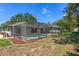 Aerial view of screened in pool with fire pit in the backyard, offering a private and relaxing outdoor oasis at 2152 Danforth Rd, Spring Hill, FL 34608