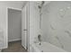 Modern bathroom with a white tiled shower and brushed nickel fixtures at 2152 Danforth Rd, Spring Hill, FL 34608