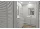 Modern bathroom with white cabinetry, dual sinks and updated fixtures at 2152 Danforth Rd, Spring Hill, FL 34608