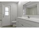 Bright bathroom with white cabinets, brushed nickel hardware, and modern fixtures at 2152 Danforth Rd, Spring Hill, FL 34608