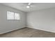 Neutral bedroom featuring a ceiling fan, and wood-look flooring at 2152 Danforth Rd, Spring Hill, FL 34608