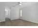 Open, airy bedroom with neutral decor, wood-look flooring and en-suite bathroom at 2152 Danforth Rd, Spring Hill, FL 34608