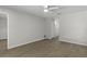 Bedroom with wood-look floors, neutral decor and access to en-suite bathroom at 2152 Danforth Rd, Spring Hill, FL 34608