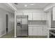 Bright kitchen shows stainless appliances, white cabinets, and modern hardware at 2152 Danforth Rd, Spring Hill, FL 34608