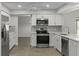 Clean kitchen showcasing white cabinets, stainless appliances, and stylish backsplash at 2152 Danforth Rd, Spring Hill, FL 34608