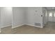Open living area with wood-look flooring, neutral walls and a front door with decorative glass at 2152 Danforth Rd, Spring Hill, FL 34608