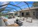 Covered pool and patio area features comfortable outdoor seating and lounge chairs for enjoying backyard relaxation at 2152 Danforth Rd, Spring Hill, FL 34608