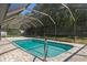 Screened in pool area with new brickwork and backyard views, offering a refreshing and private oasis at 2152 Danforth Rd, Spring Hill, FL 34608