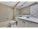 Cozy bathroom with tub, and vanity with decorative countertop and full mirrored wall at 2169 Danforth Rd, Spring Hill, FL 34608