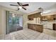 Open-concept dining area featuring tiled floors, wood accents, and access to a screened porch at 2169 Danforth Rd, Spring Hill, FL 34608