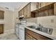 A kitchen featuring white appliances and wood cabinetry at 2169 Danforth Rd, Spring Hill, FL 34608