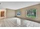Open living room with tile floors, neutral paint, and natural light streaming through the windows at 2169 Danforth Rd, Spring Hill, FL 34608