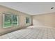 Bright, spacious living room with large windows that offer a pleasant outdoor view and tiled floors at 2169 Danforth Rd, Spring Hill, FL 34608
