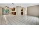 Spacious room with tiled floors and access to the kitchen and a screened-in patio at 2169 Danforth Rd, Spring Hill, FL 34608