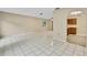 Spacious living area with white tile flooring, light walls, arched doorways, and a ceiling fan at 2169 Danforth Rd, Spring Hill, FL 34608
