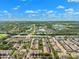 Extensive aerial view of a community featuring multiple pools, lakes, green belts, and well-maintained homes at 2209 Kings Palace Dr # 21-204, Riverview, FL 33578