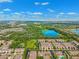 Beautiful aerial shot showcases a neighborhood with a lake, manicured lawns, and tree-lined streets at 2209 Kings Palace Dr # 21-204, Riverview, FL 33578