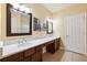 Bright bathroom with double vanity, white marble countertop, dark wood cabinets, and decorative artwork at 2209 Kings Palace Dr # 21-204, Riverview, FL 33578
