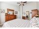 Well-lit bedroom with carpet, showing a dresser, mirror, and entry to the bathroom at 2209 Kings Palace Dr # 21-204, Riverview, FL 33578