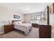 Cozy bedroom with carpet, featuring a dresser and decorative windows, creating a relaxing space at 2209 Kings Palace Dr # 21-204, Riverview, FL 33578
