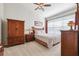 Bright bedroom with a ceiling fan, wooden furniture, and soft, patterned bedding at 2209 Kings Palace Dr # 21-204, Riverview, FL 33578