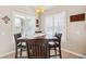 Cozy dining area featuring shuttered windows, pendant lighting and a stylish dark wood table at 2209 Kings Palace Dr # 21-204, Riverview, FL 33578