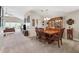 Inviting dining room with classic wood table, chairs, and china cabinet for elegant meals and entertaining at 2209 Kings Palace Dr # 21-204, Riverview, FL 33578