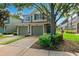 Charming townhouse with a two-car garage, green shutters, and mature trees in a quiet community at 2209 Kings Palace Dr # 21-204, Riverview, FL 33578