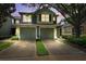 Inviting townhome exterior with a two-car garage, set against a tranquil dusk sky at 2209 Kings Palace Dr # 21-204, Riverview, FL 33578