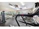Bright gym featuring treadmills, weight machines, mirrors, and ceiling fans for a comfortable workout at 2209 Kings Palace Dr # 21-204, Riverview, FL 33578