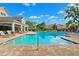 Inviting community pool with a brick surround, lounge chairs, and clear blue water for relaxation at 2209 Kings Palace Dr # 21-204, Riverview, FL 33578