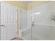 Tiled walk-in shower features glass door and bench, providing a modern and comfortable bathing experience at 2209 Kings Palace Dr # 21-204, Riverview, FL 33578