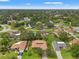 Aerial view showcasing a residential neighborhood with houses, trees, and a serene lake at 23302 Lucerne Pl, Land O Lakes, FL 34639