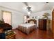 Comfortable bedroom with hardwood floors, a ceiling fan, and traditional decor at 23302 Lucerne Pl, Land O Lakes, FL 34639