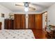 Bedroom featuring hardwood floors, closet, and a ceiling fan at 23302 Lucerne Pl, Land O Lakes, FL 34639