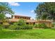 Well-maintained home with lush green lawn and mature trees offering shade and curb appeal at 23302 Lucerne Pl, Land O Lakes, FL 34639