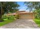 Charming home features a two-car garage and meticulously maintained landscaping and a long driveway at 23302 Lucerne Pl, Land O Lakes, FL 34639