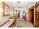 Inviting hallway with tile floors, decorative table, and an entry to the living room at 23302 Lucerne Pl, Land O Lakes, FL 34639