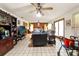 Spacious living room with tile floors, ceiling fan, and plenty of natural light at 23302 Lucerne Pl, Land O Lakes, FL 34639