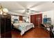 Spacious main bedroom featuring wood floors, ceiling fan, and large windows at 23302 Lucerne Pl, Land O Lakes, FL 34639
