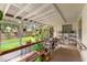 Cozy screened porch with plenty of potted plants and views of the fenced backyard at 23302 Lucerne Pl, Land O Lakes, FL 34639