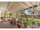 Relaxing screened porch with plants and views of the backyard, perfect for enjoying the outdoors at 23302 Lucerne Pl, Land O Lakes, FL 34639