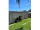 Backyard features a stepping stone pathway and ample grass at 3238 Coldwell Dr, Holiday, FL 34691