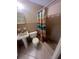 Small bathroom featuring tile floors, sink, toilet, and shower with curtain at 3238 Coldwell Dr, Holiday, FL 34691