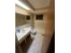 Compact bathroom featuring tile floors, a vanity, a skylight, and a shower-tub combo at 3238 Coldwell Dr, Holiday, FL 34691