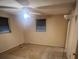 Empty bedroom with carpet, two windows, and a ceiling fan with light at 3238 Coldwell Dr, Holiday, FL 34691