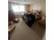 Cluttered bedroom with carpet, a large window, and personal belongings at 3238 Coldwell Dr, Holiday, FL 34691