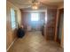 Kitchen area with wood paneled walls, tile floors, and window at 3238 Coldwell Dr, Holiday, FL 34691